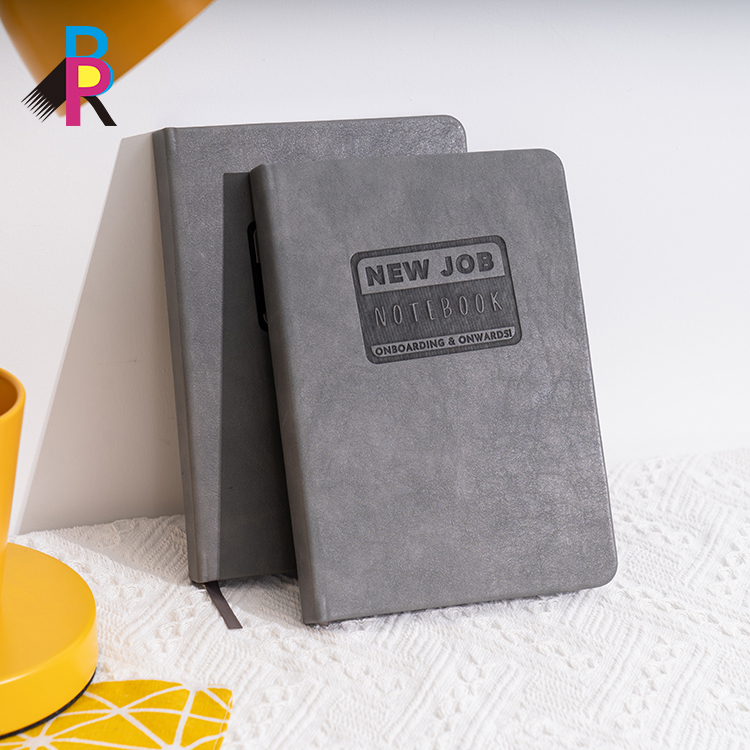 A notebook with "New Job" written on the cover.